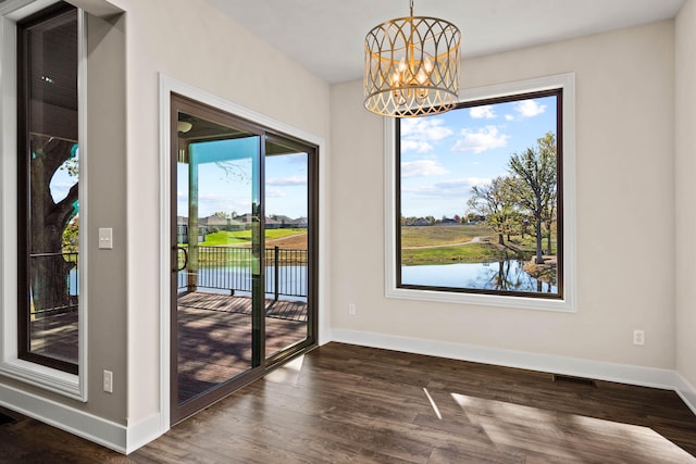 interior space with a chandelier, dark wood-type flooring, and a wealth of natural light