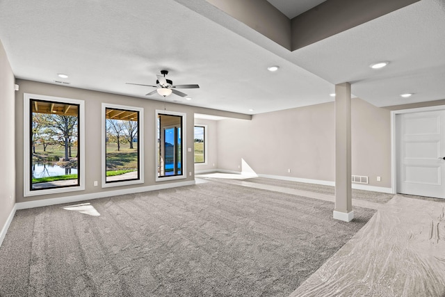 interior space featuring ceiling fan and a textured ceiling