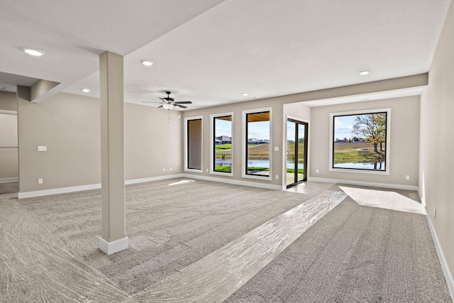 unfurnished living room with light carpet and ceiling fan