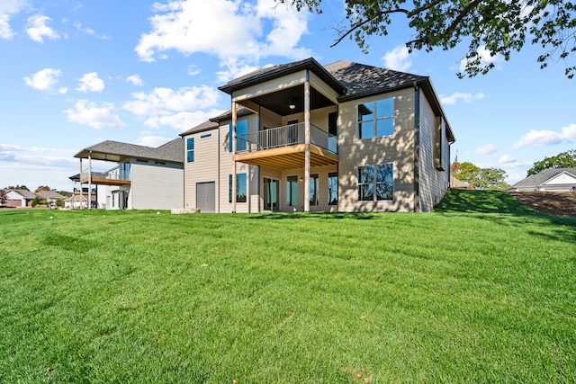 back of house featuring a lawn and a balcony