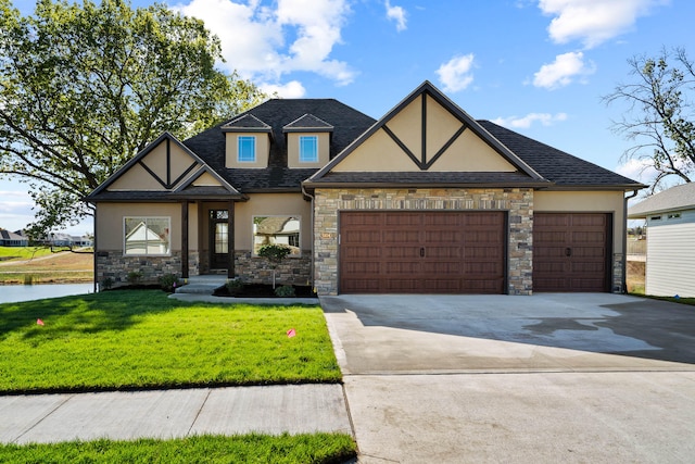 tudor house featuring a front yard and a garage