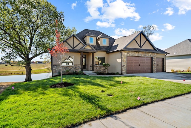 tudor house featuring a front yard and a garage