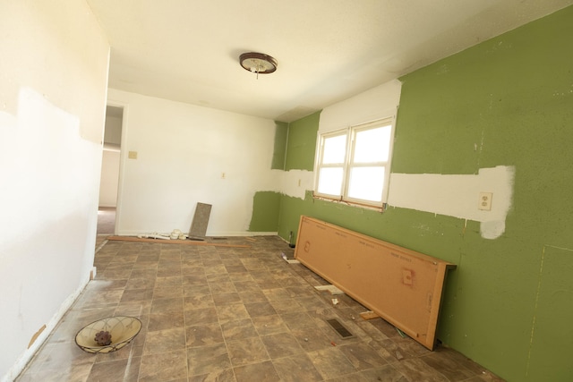 spare room featuring dark tile floors