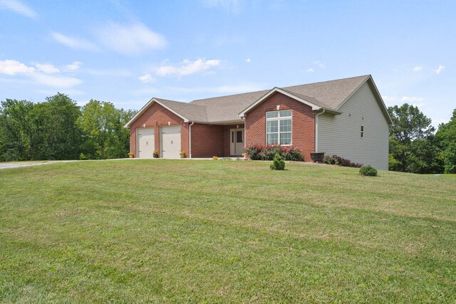 single story home with a garage and a front yard