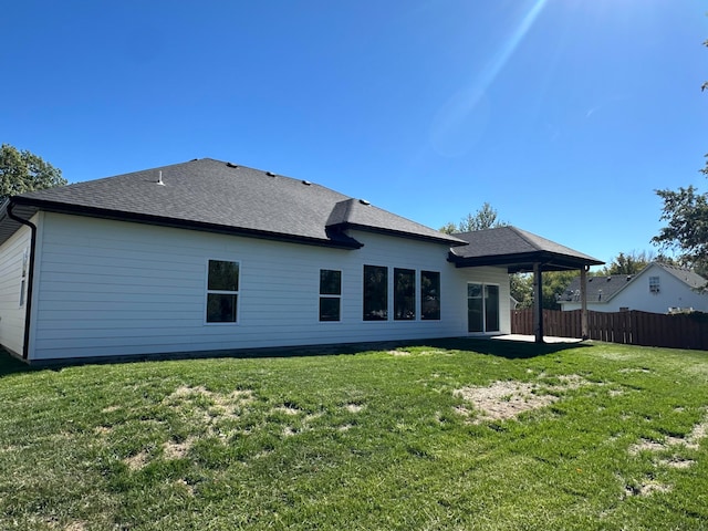 rear view of house featuring a yard and a patio area