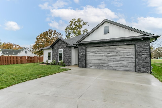 view of front of home featuring a garage and a front lawn