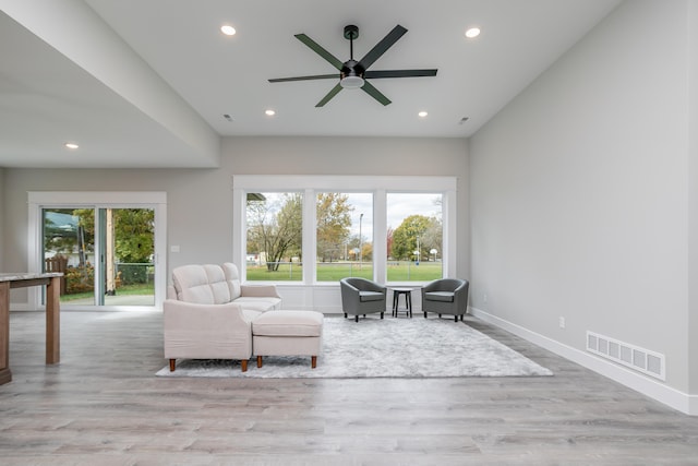 unfurnished living room with light hardwood / wood-style flooring and ceiling fan