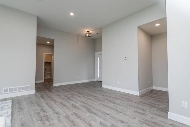 empty room with light hardwood / wood-style flooring