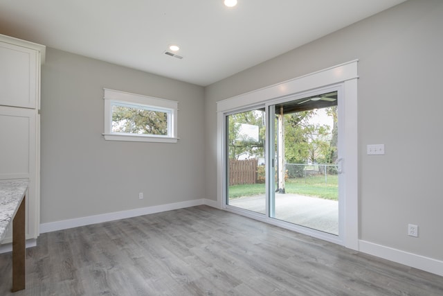 unfurnished dining area with light hardwood / wood-style floors and a healthy amount of sunlight