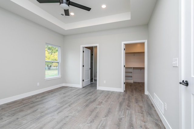 108 Lisa Ct, Hallsville, MO 65255 - unfurnished bedroom featuring a walk in closet, light wood-type flooring, recessed lighting, baseboards, and a closet