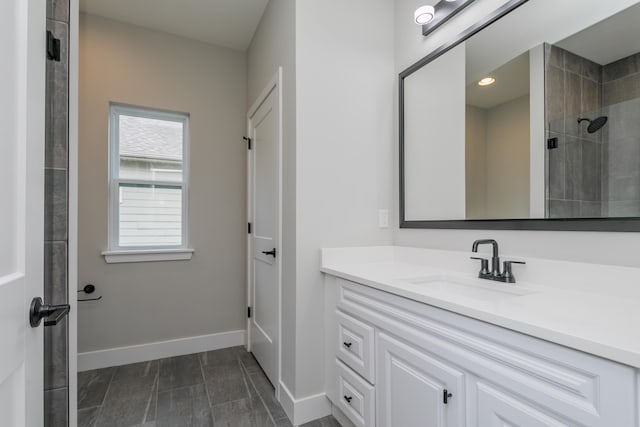 bathroom with vanity and a tile shower