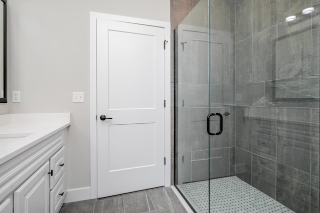 bathroom with walk in shower and vanity