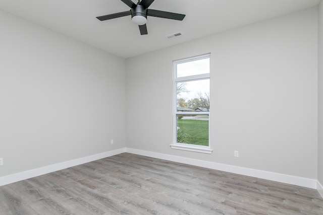 empty room featuring ceiling fan and light hardwood / wood-style flooring