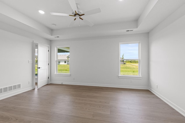 spare room with light hardwood / wood-style floors, plenty of natural light, and ceiling fan