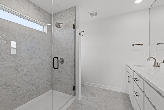 bathroom with vanity and a shower with door