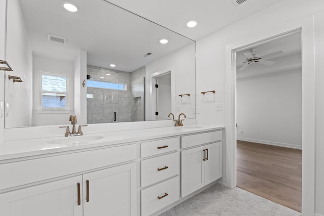 bathroom featuring ceiling fan, vanity, a shower with shower door, and wood-type flooring