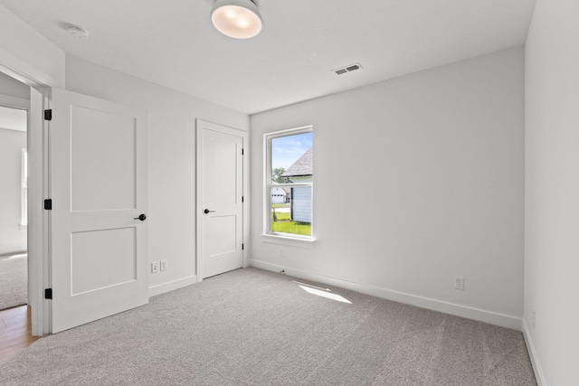 unfurnished bedroom with light colored carpet