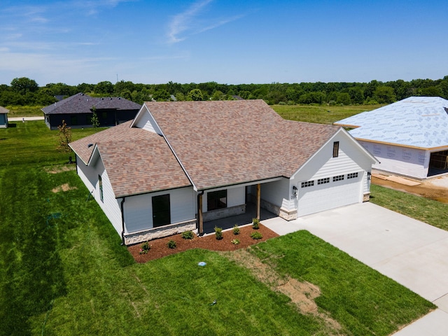 view of front of house featuring a front yard and a garage