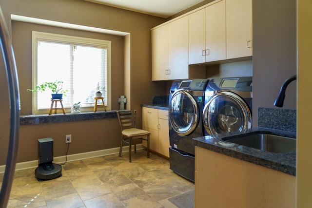 laundry room with sink, cabinets, light tile floors, and separate washer and dryer