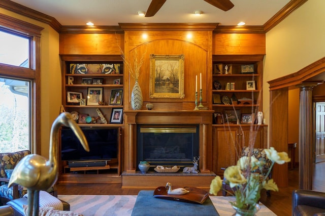 living room featuring a wealth of natural light, hardwood / wood-style floors, ceiling fan, and built in shelves