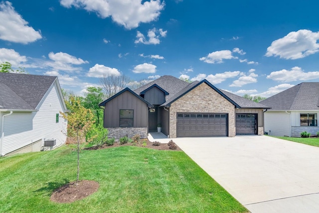 view of front of house with cooling unit, a front yard, and a garage