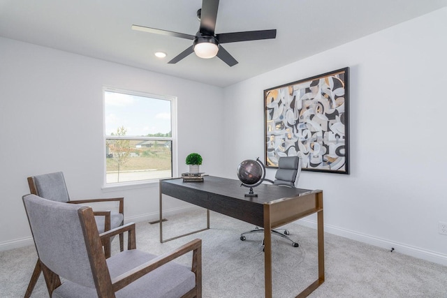 carpeted office space featuring ceiling fan