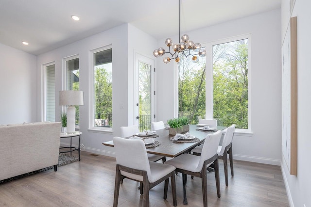 dining area with a chandelier and light wood-type flooring