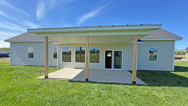 rear view of property featuring a patio area and a lawn