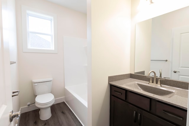 full bathroom featuring vanity, toilet, bathing tub / shower combination, and hardwood / wood-style floors