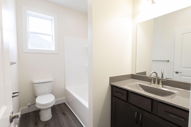 full bathroom with vanity, toilet, wood finished floors, and baseboards