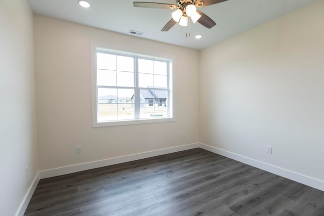 unfurnished room featuring ceiling fan and dark wood-type flooring