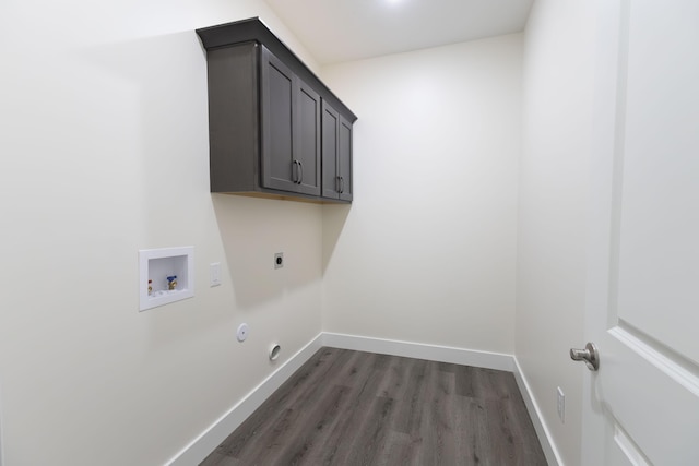 laundry room with dark wood-style floors, cabinet space, baseboards, hookup for an electric dryer, and hookup for a washing machine