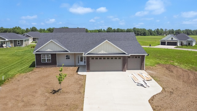 ranch-style home featuring concrete driveway, a garage, a front yard, and a shingled roof