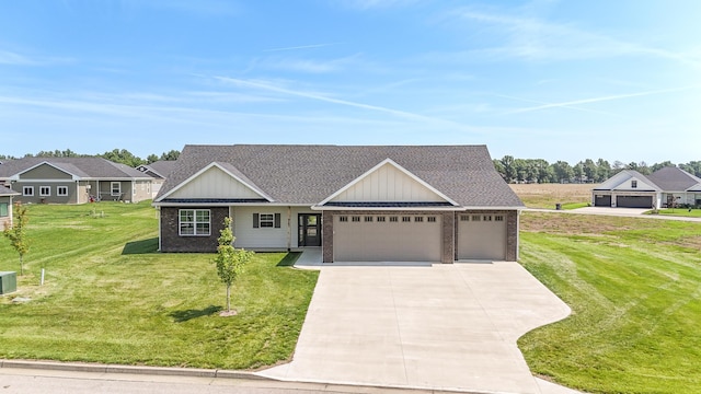 911 Destinee Dr, Moberly, MO 65270 - view of front of house with an attached garage, concrete driveway, a front lawn, roof with shingles, and brick siding