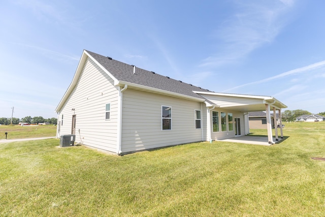 911 Destinee Dr, Moberly, MO 65270 - back of house featuring a patio, a yard, and a shingled roof