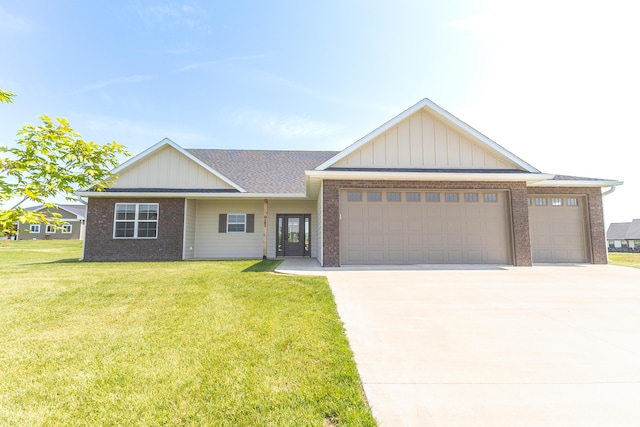 911 Destinee Dr, Moberly, MO 65270 - view of front of house featuring a garage, brick siding, and driveway