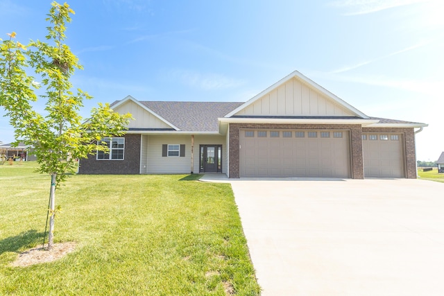 911 Destinee Dr, Moberly, MO 65270 - view of front of home with a garage, brick siding, and driveway