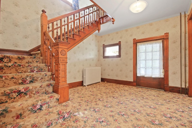 staircase featuring radiator heating unit and carpet floors