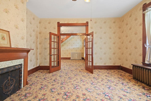 carpeted living room with french doors and radiator heating unit