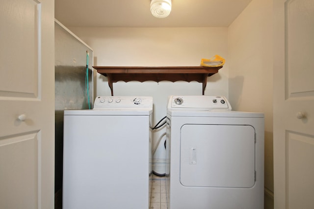 laundry room featuring separate washer and dryer and light tile floors