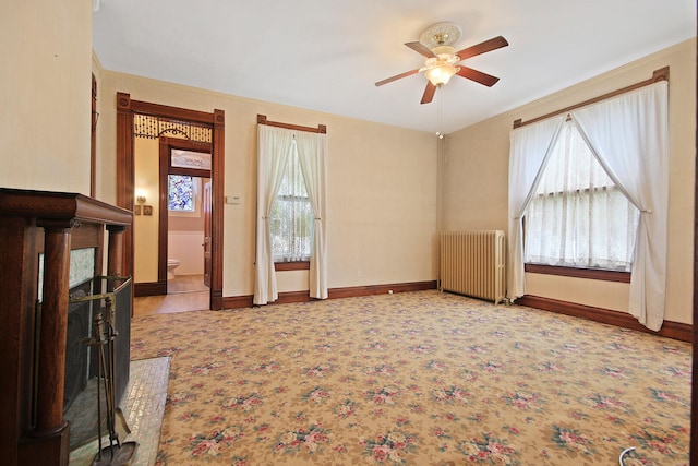 living room with radiator and ceiling fan