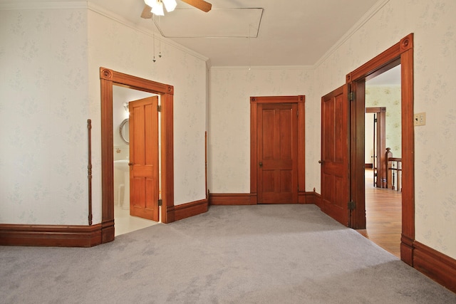 hallway featuring crown molding and light carpet