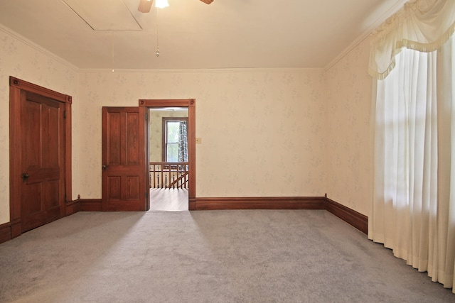 unfurnished room featuring carpet floors, ceiling fan, and ornamental molding