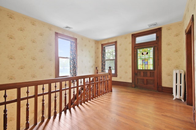 entrance foyer featuring hardwood / wood-style floors and radiator heating unit