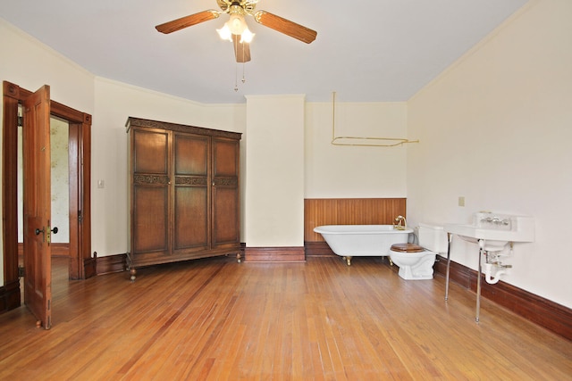 interior space featuring hardwood / wood-style floors, ceiling fan, and sink