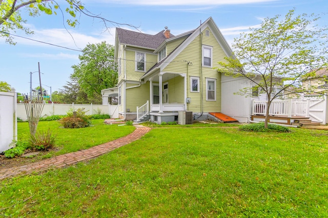 view of front of home featuring a front lawn and central air condition unit