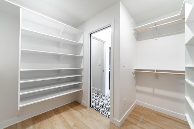 spacious closet with light hardwood / wood-style flooring