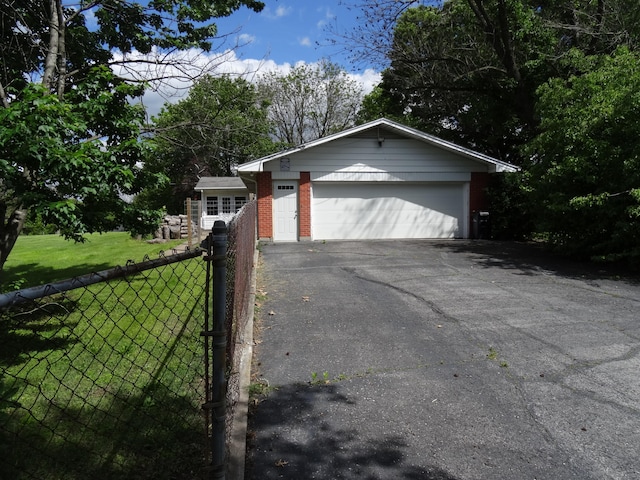 ranch-style house featuring a garage and a front yard