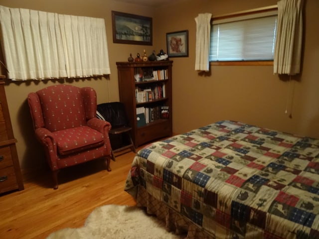 bedroom with hardwood / wood-style floors