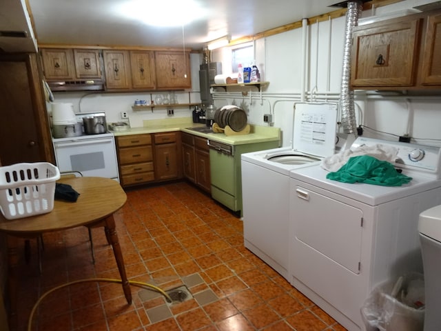 laundry room with washing machine and dryer and dark tile floors